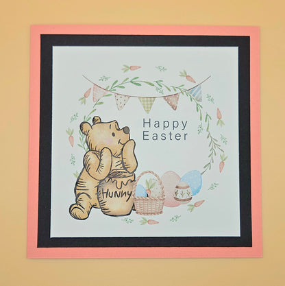 Framed artwork with a bear holding a honey pot and 'Happy Easter' text on a light blue background.