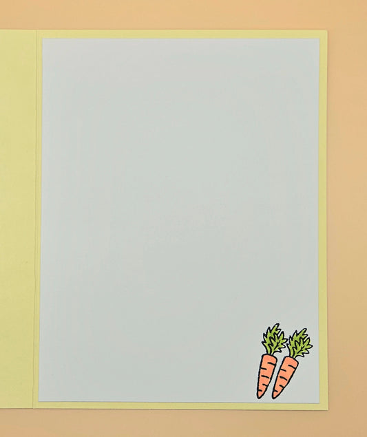 Two cartoon carrots on a light gray background with a yellow border.