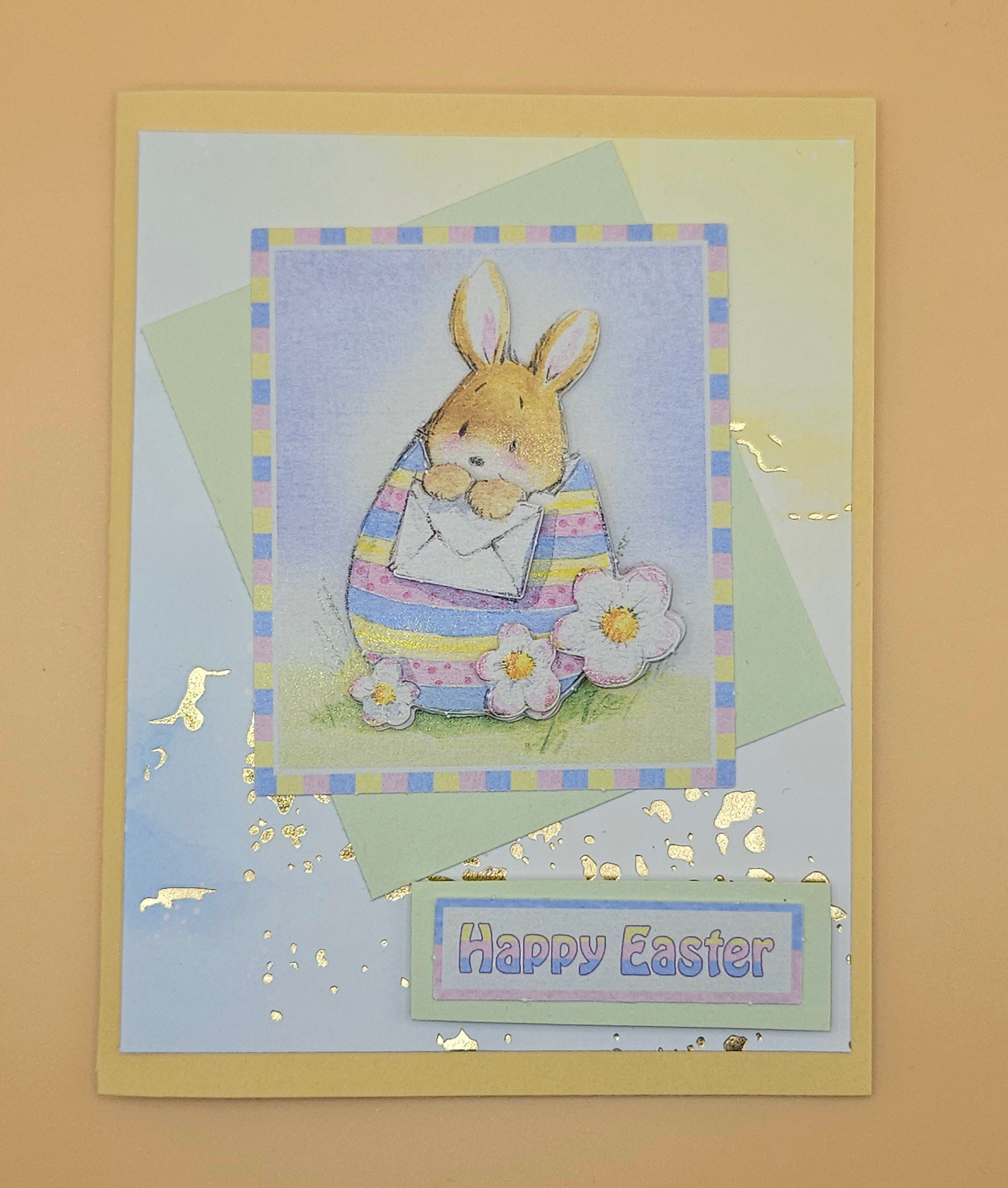 Easter card with a bunny and flowers on a light blue background