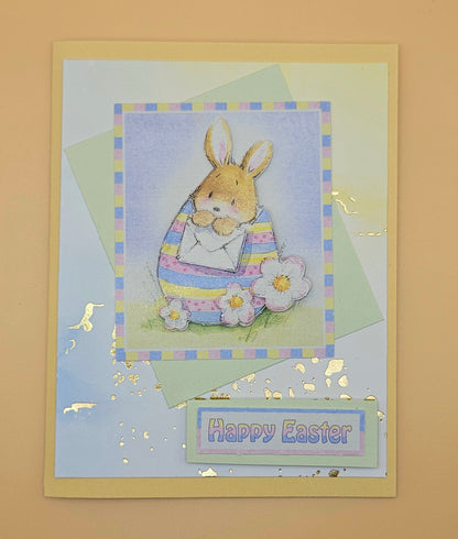 Easter card with a bunny and flowers on a light blue background