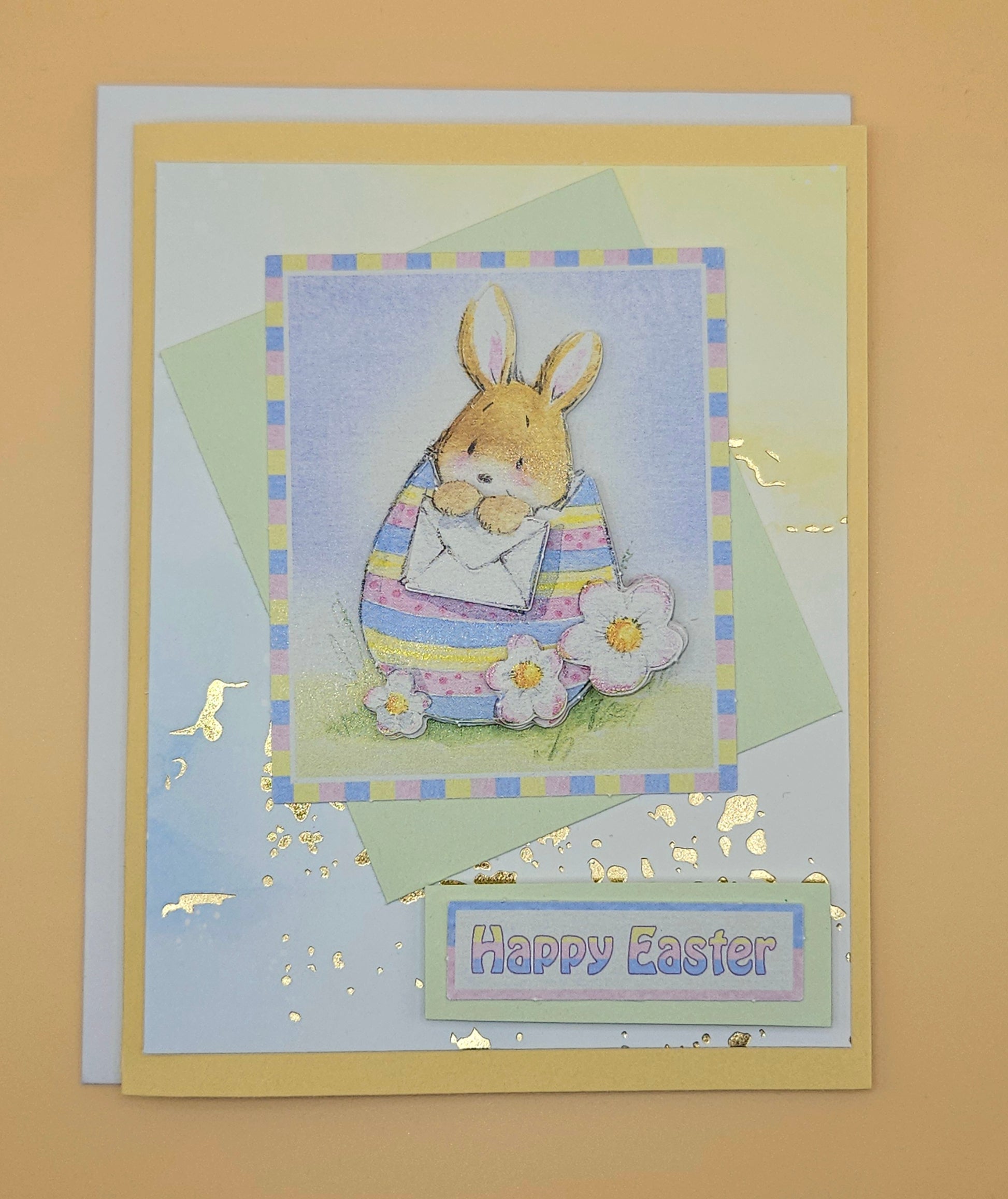 Easter card with a bunny holding a flower on a beige background