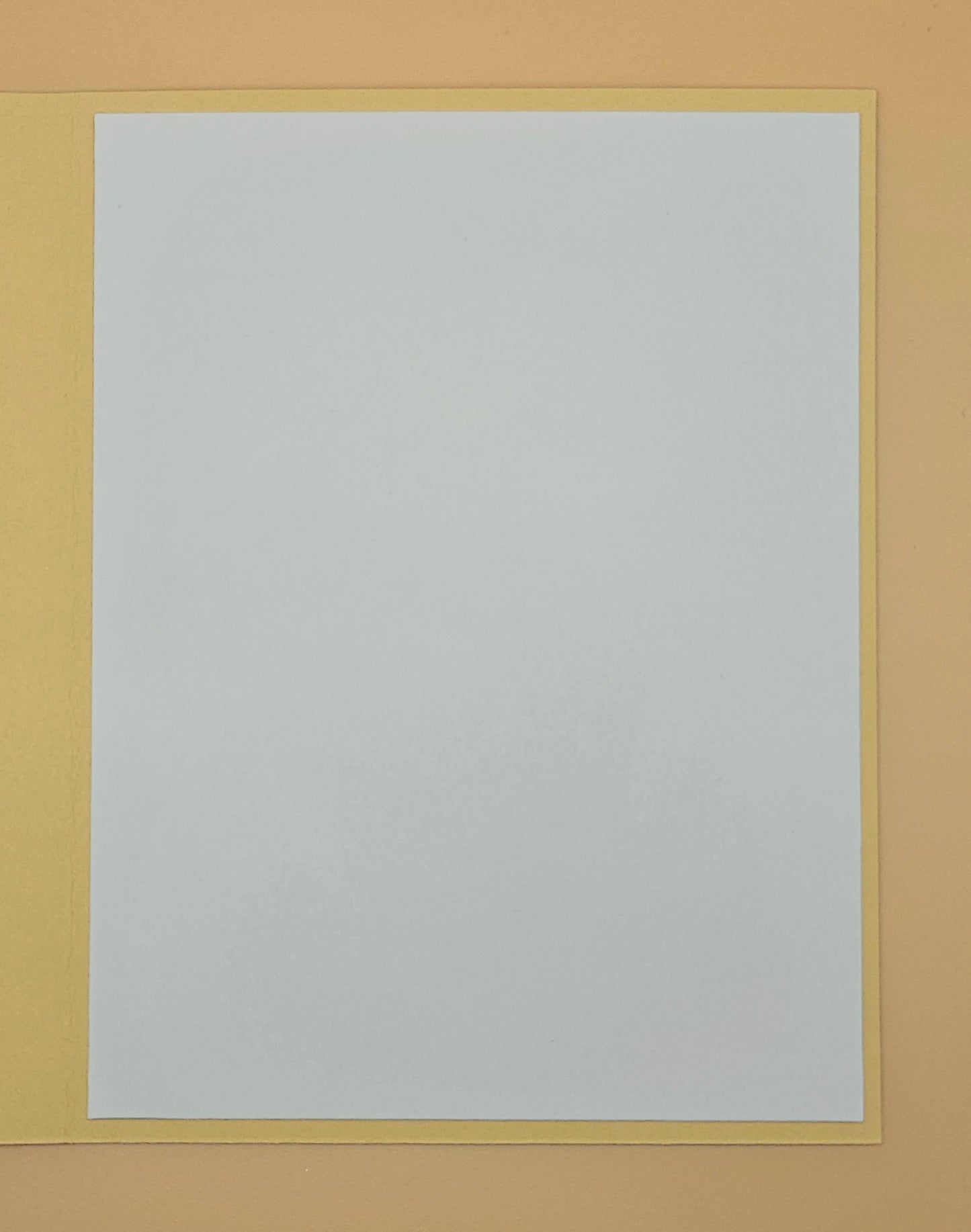 White sheet of paper with a yellow border on a beige background