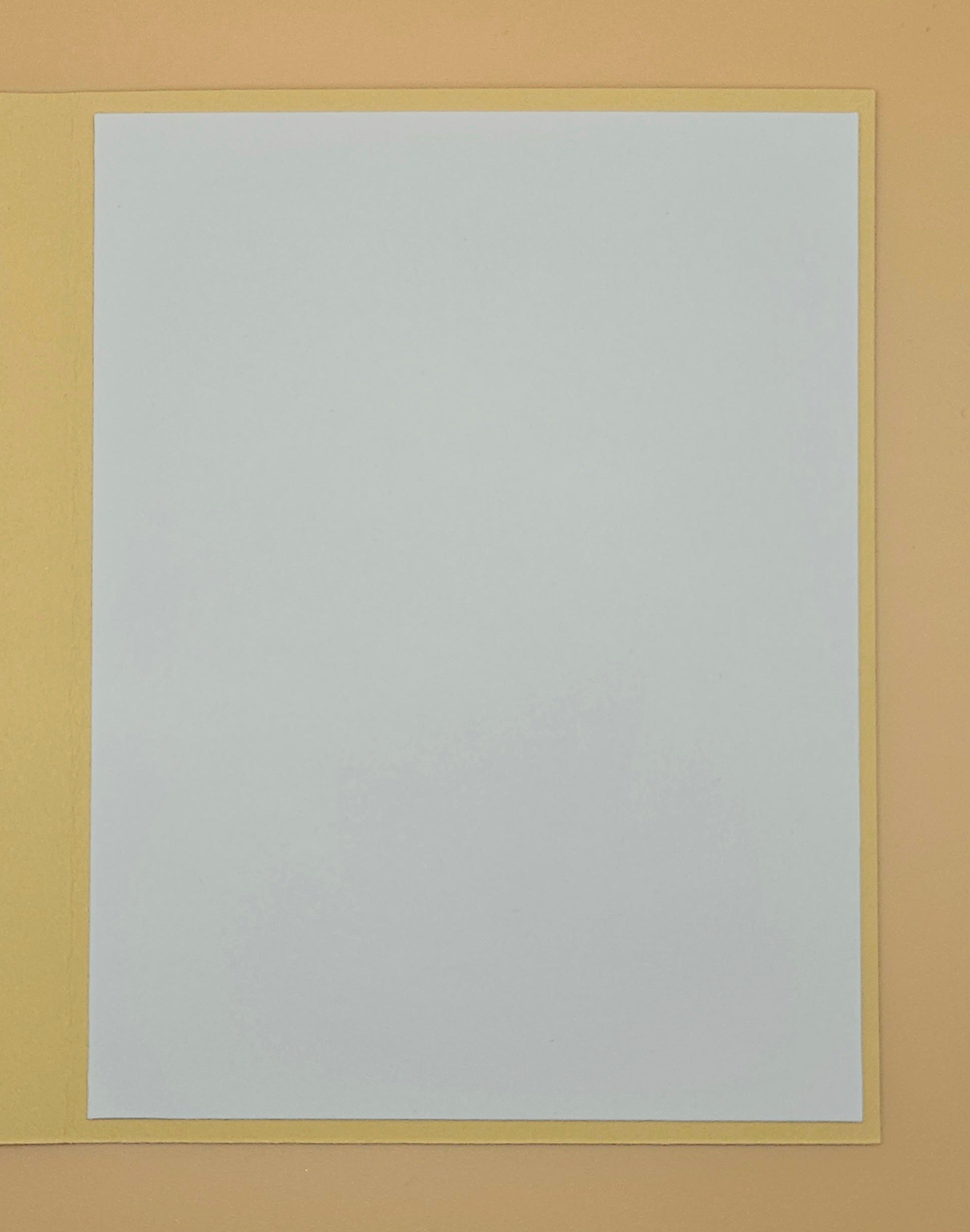 White sheet of paper with a yellow border on a beige background
