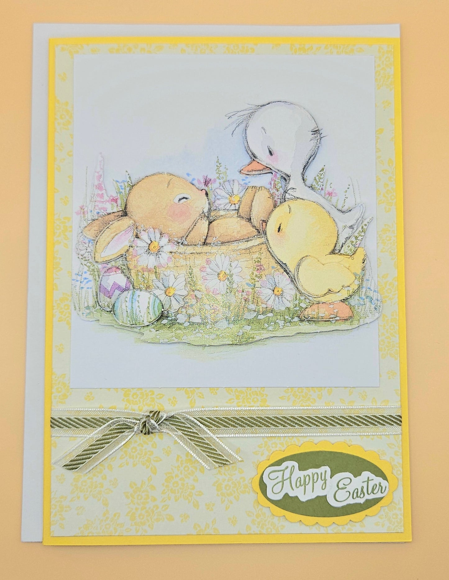 Easter card with teddy bear, ducklings, and basket of eggs on a yellow background