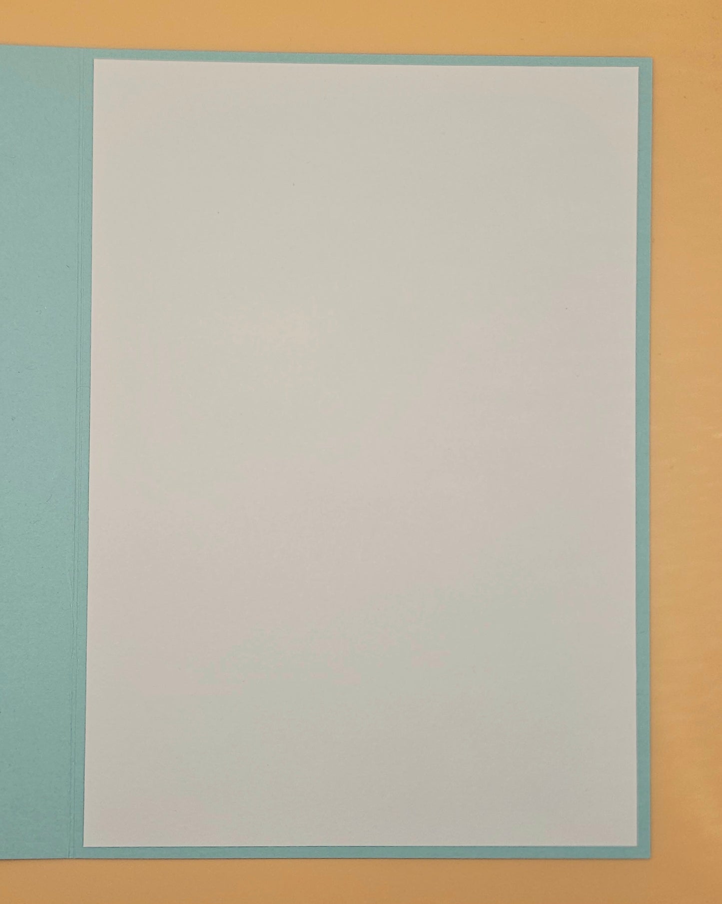 Plain white card with a light blue border on a beige background