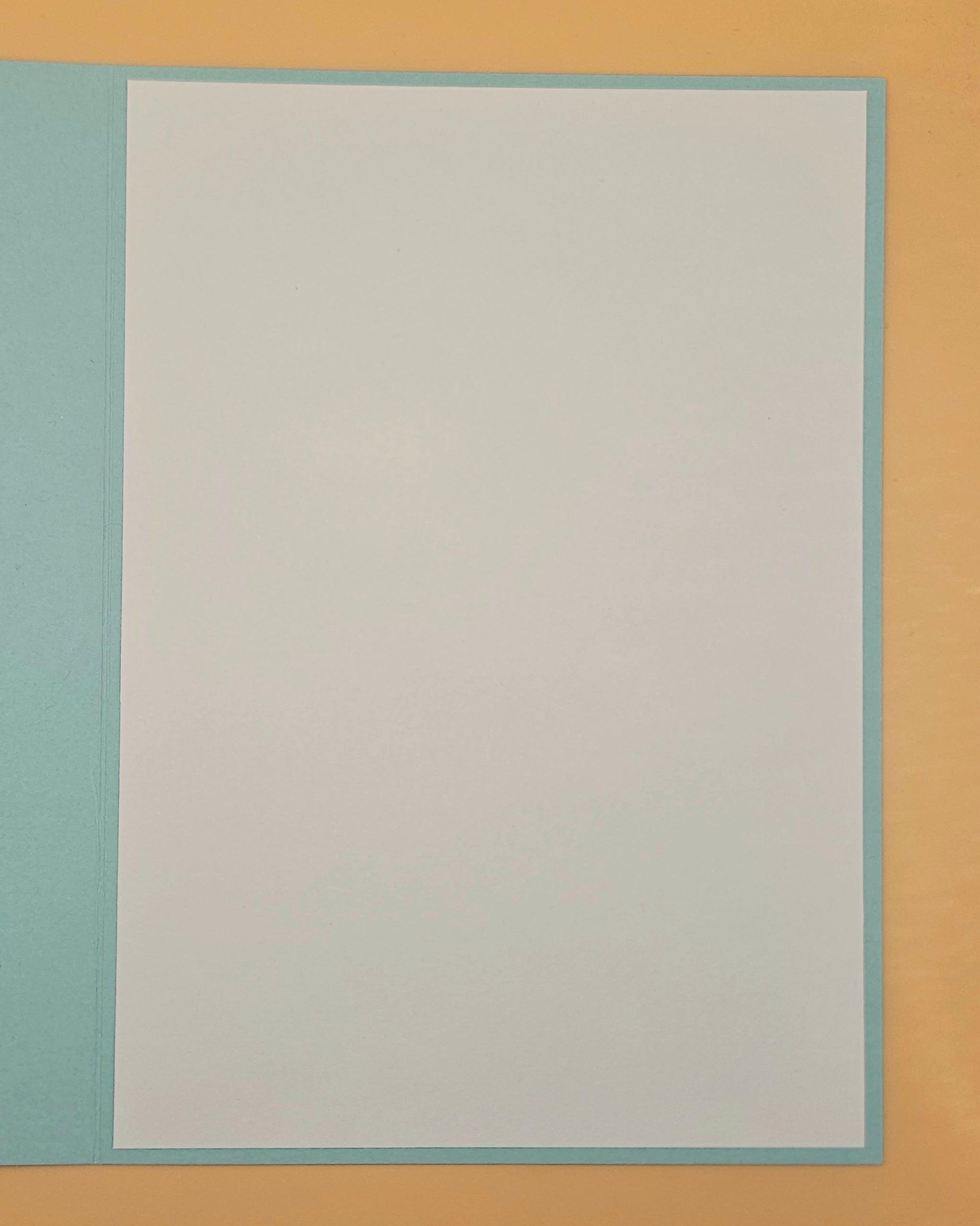 Plain white card with a light blue border on a beige background