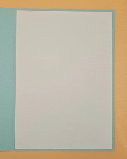 Plain white card with a light blue border on a beige background