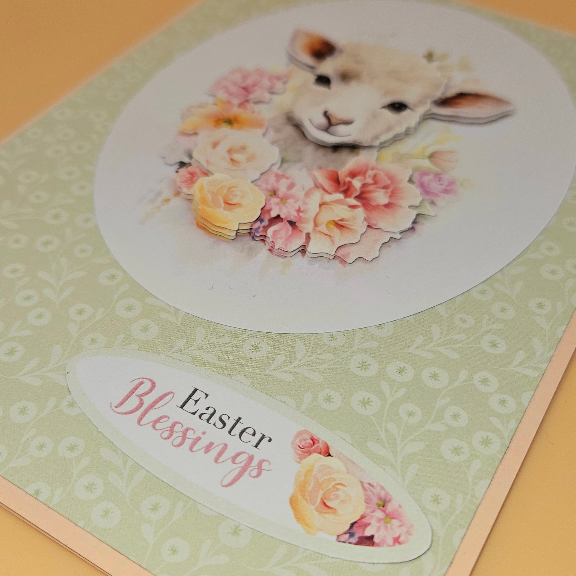 Easter card with a lamb and flowers on a green background