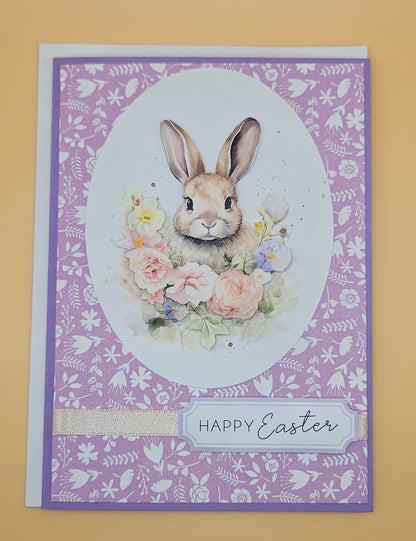 Easter card with a bunny and flowers on a purple patterned background