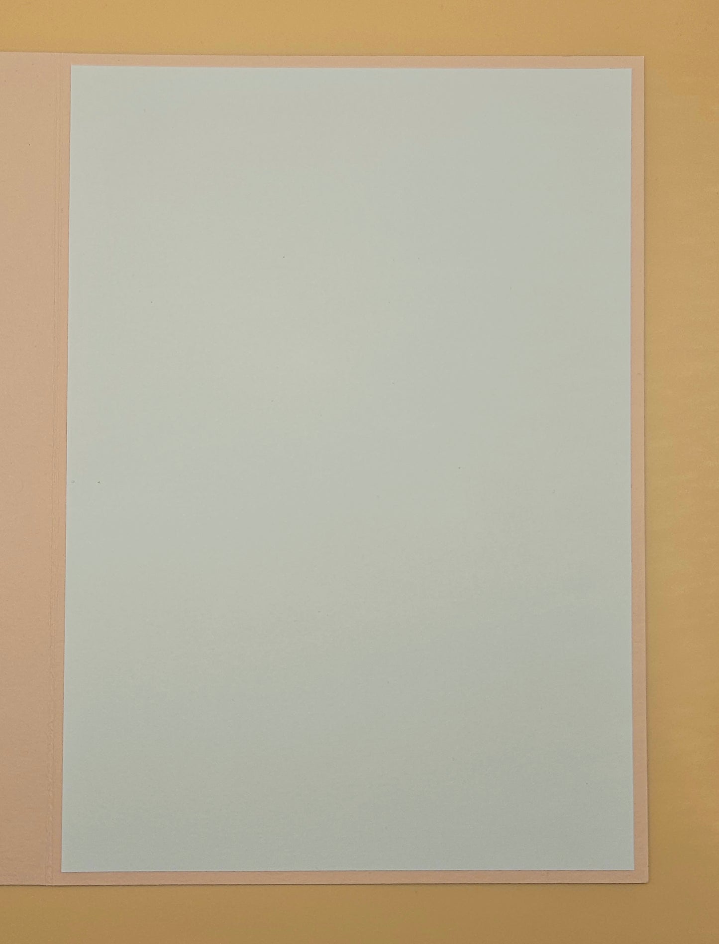 White sheet of paper on a beige background