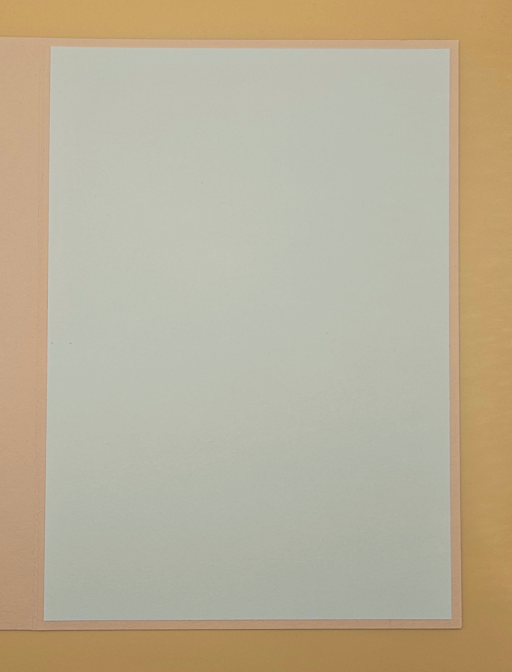 White sheet of paper on a beige background
