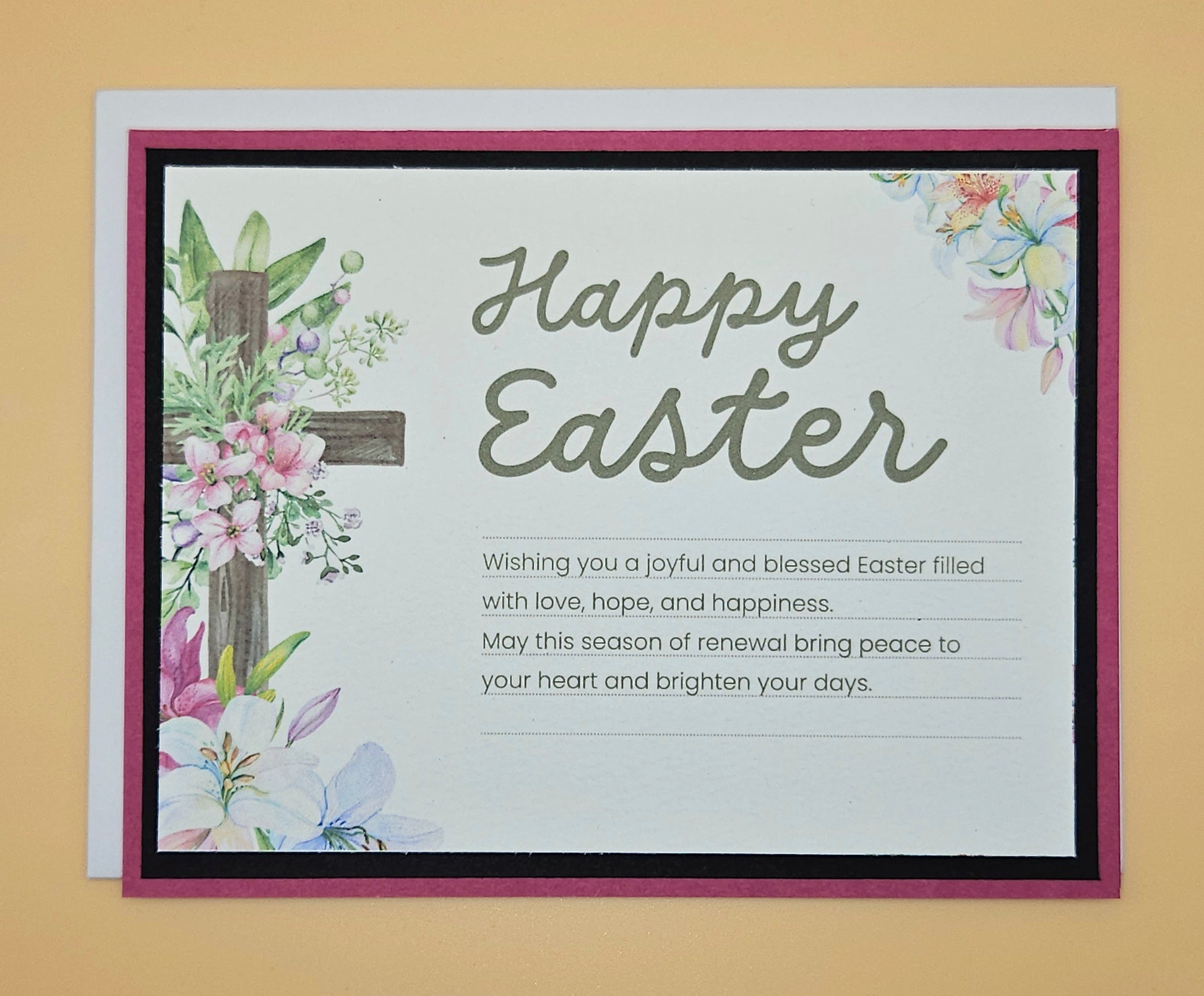 Easter card with floral designs and a message on a beige background