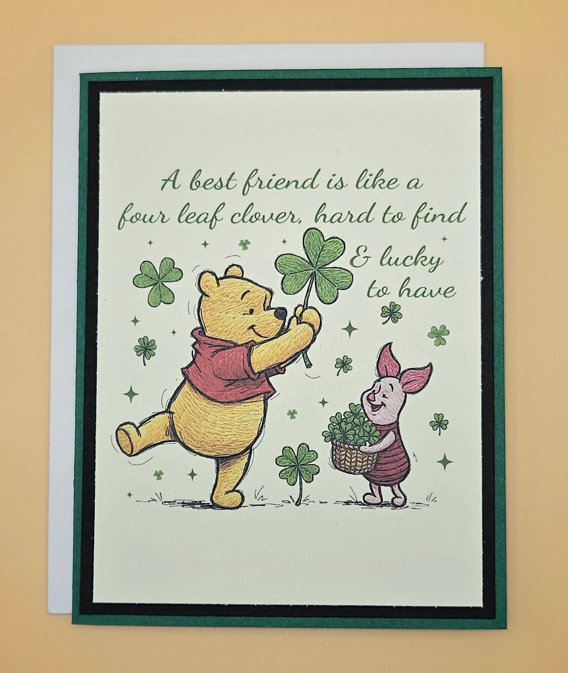 Card with Winnie the Pooh and Piglet holding four-leaf clovers on a beige background