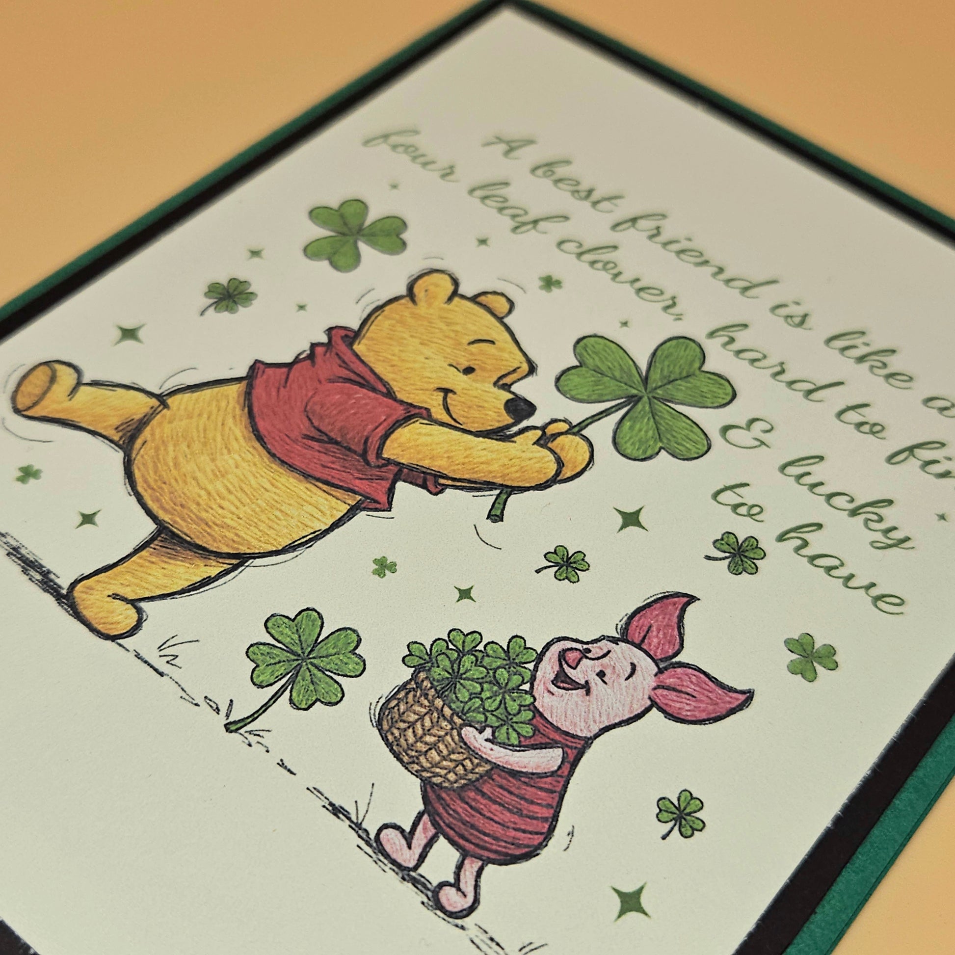 Illustration of Winnie the Pooh and Piglet holding four-leaf clovers with text on a card.