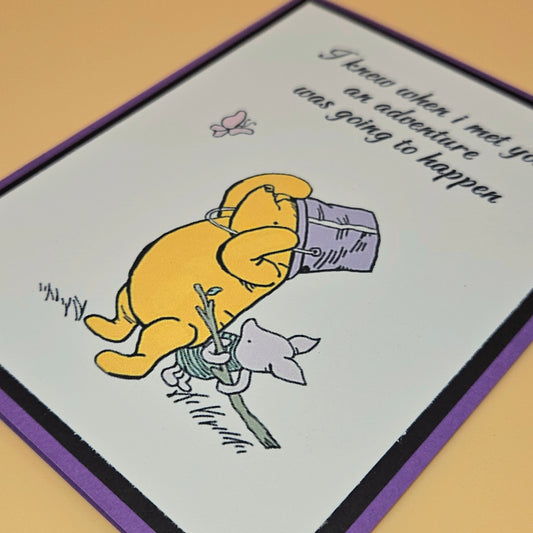 Cartoon bear holding a flower with text on a card