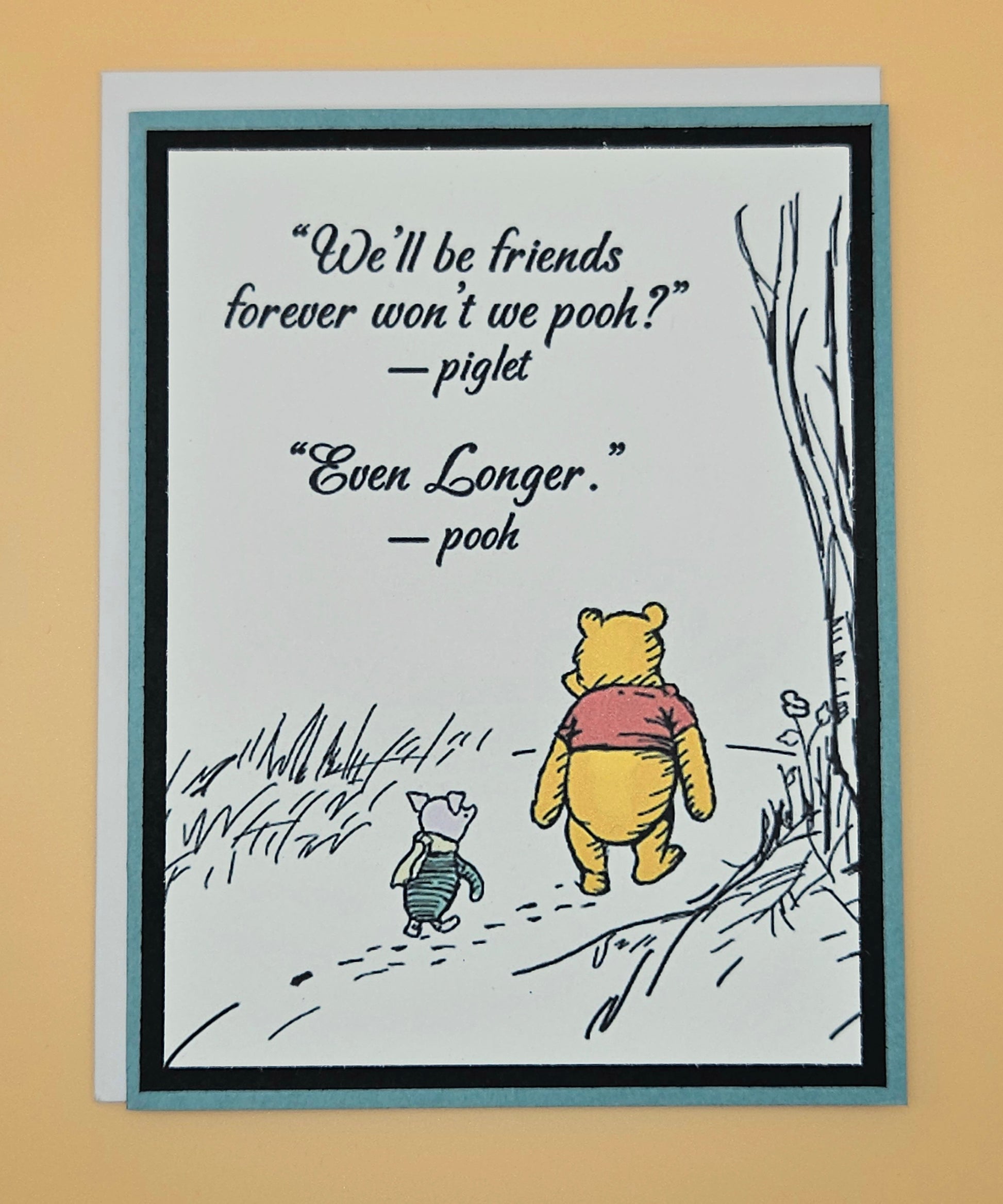 Card with Winnie the Pooh and Piglet illustration and friendship quote on a beige background