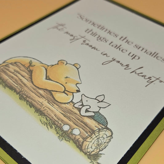 Illustration of a bear and mouse on a log with a quote about small things taking up space in your heart.