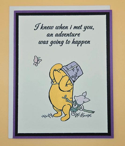 Card with cartoon character holding a suitcase and text 'I knew when I met you, an adventure was going to happen'.