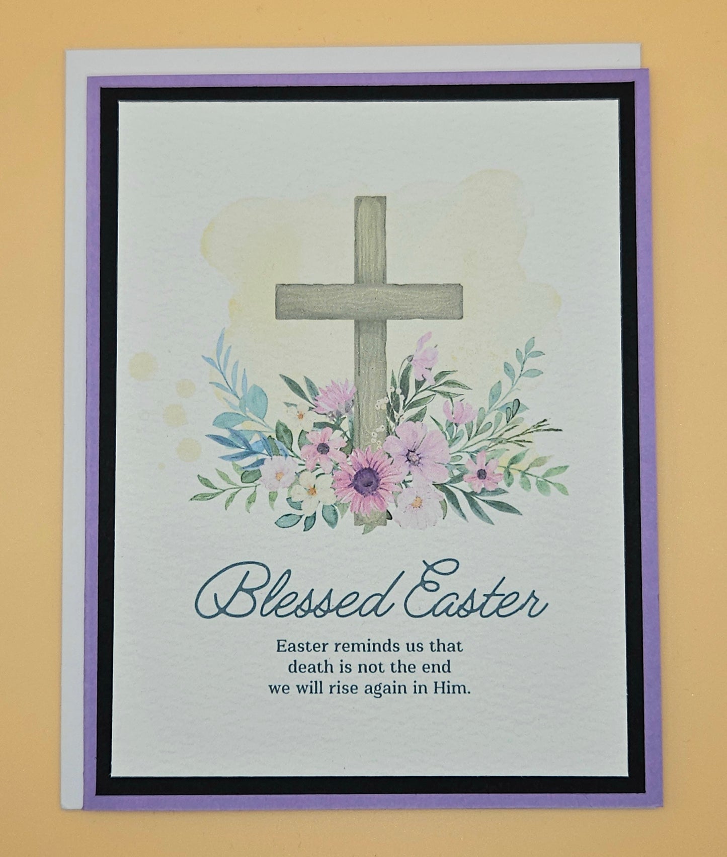 Easter card with cross and flowers on a beige background