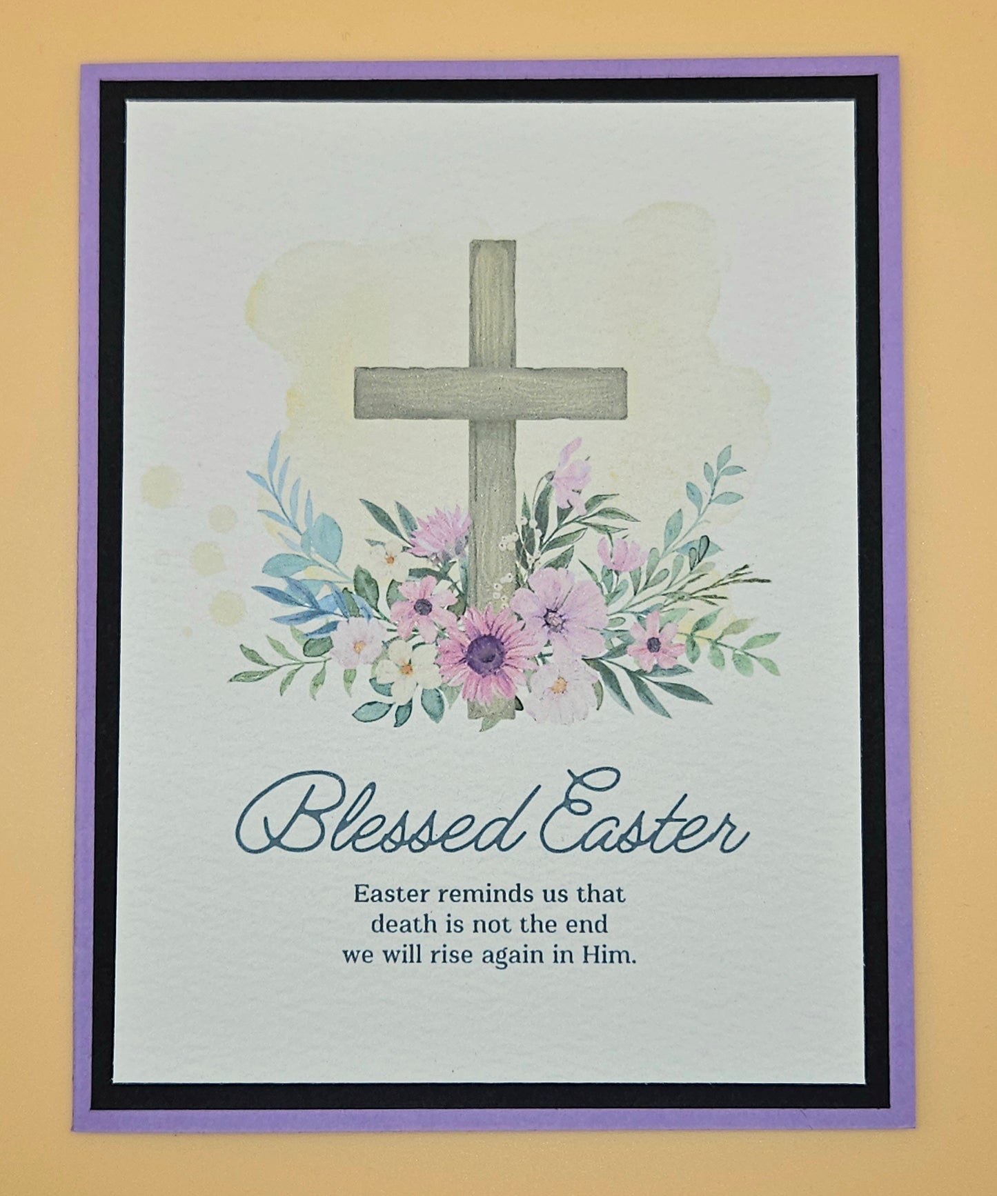 Framed artwork with a cross, flowers, and 'Blessed Easter' text on a light background.