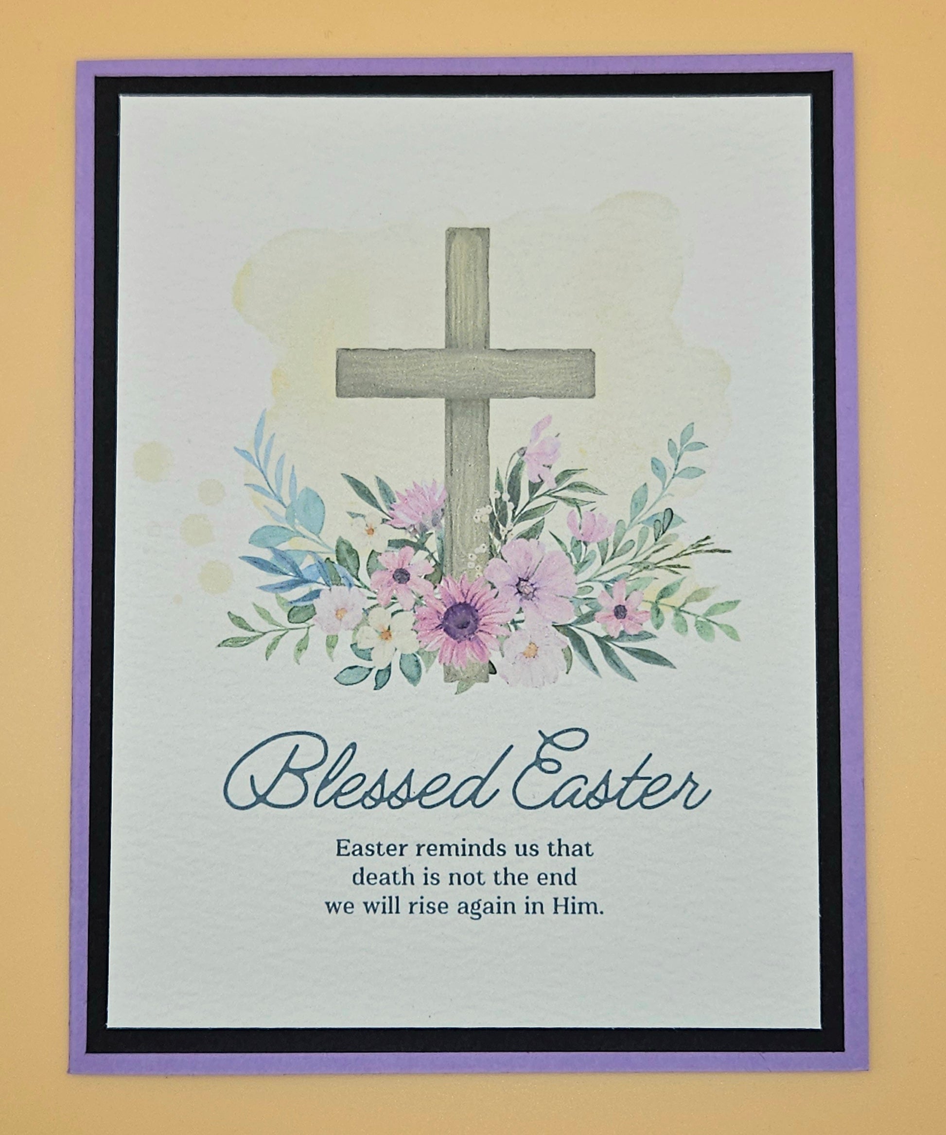 Framed artwork with a cross, flowers, and 'Blessed Easter' text on a light background.