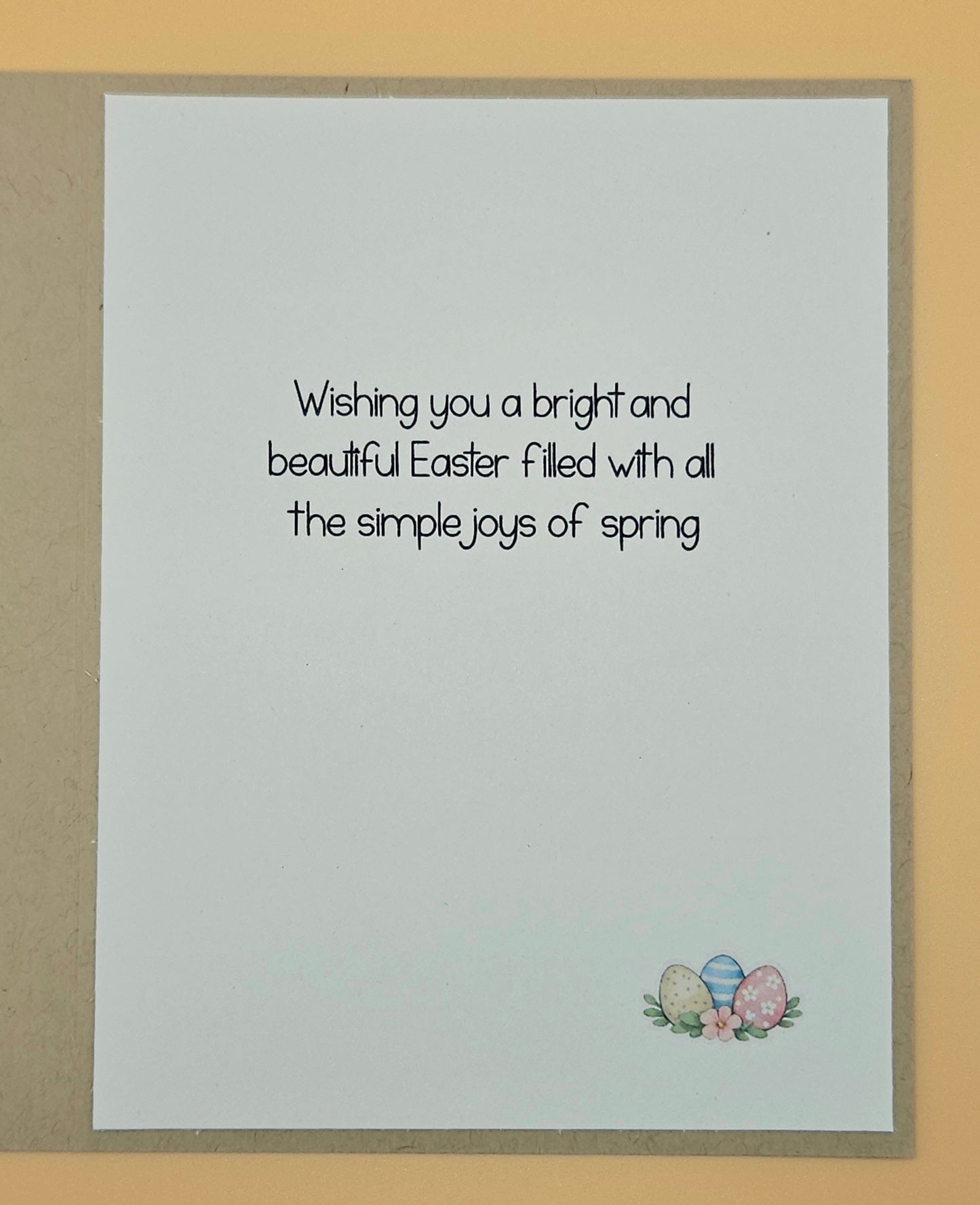 Easter card with text and Easter eggs on a beige background