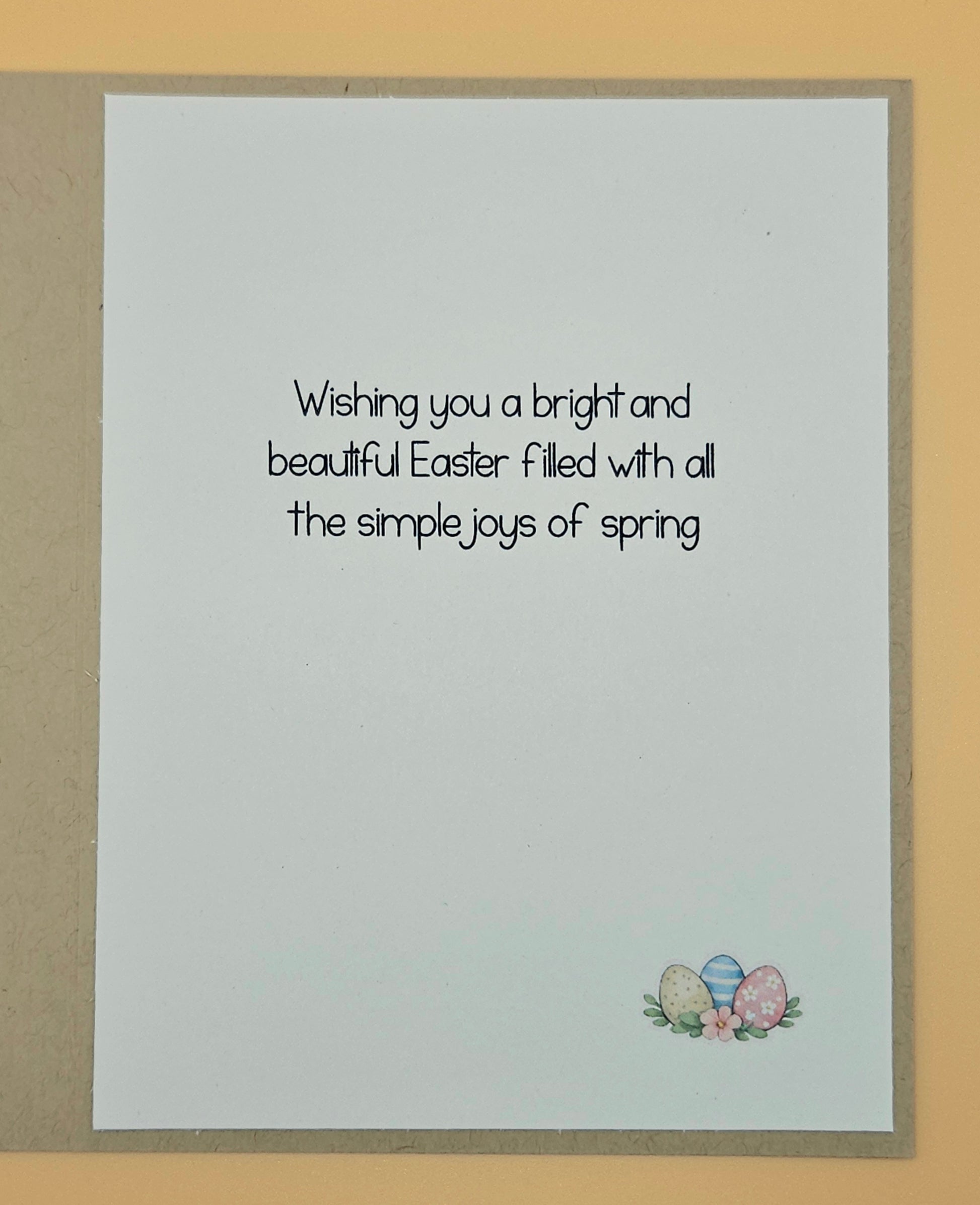 Easter card with text and Easter eggs on a beige background