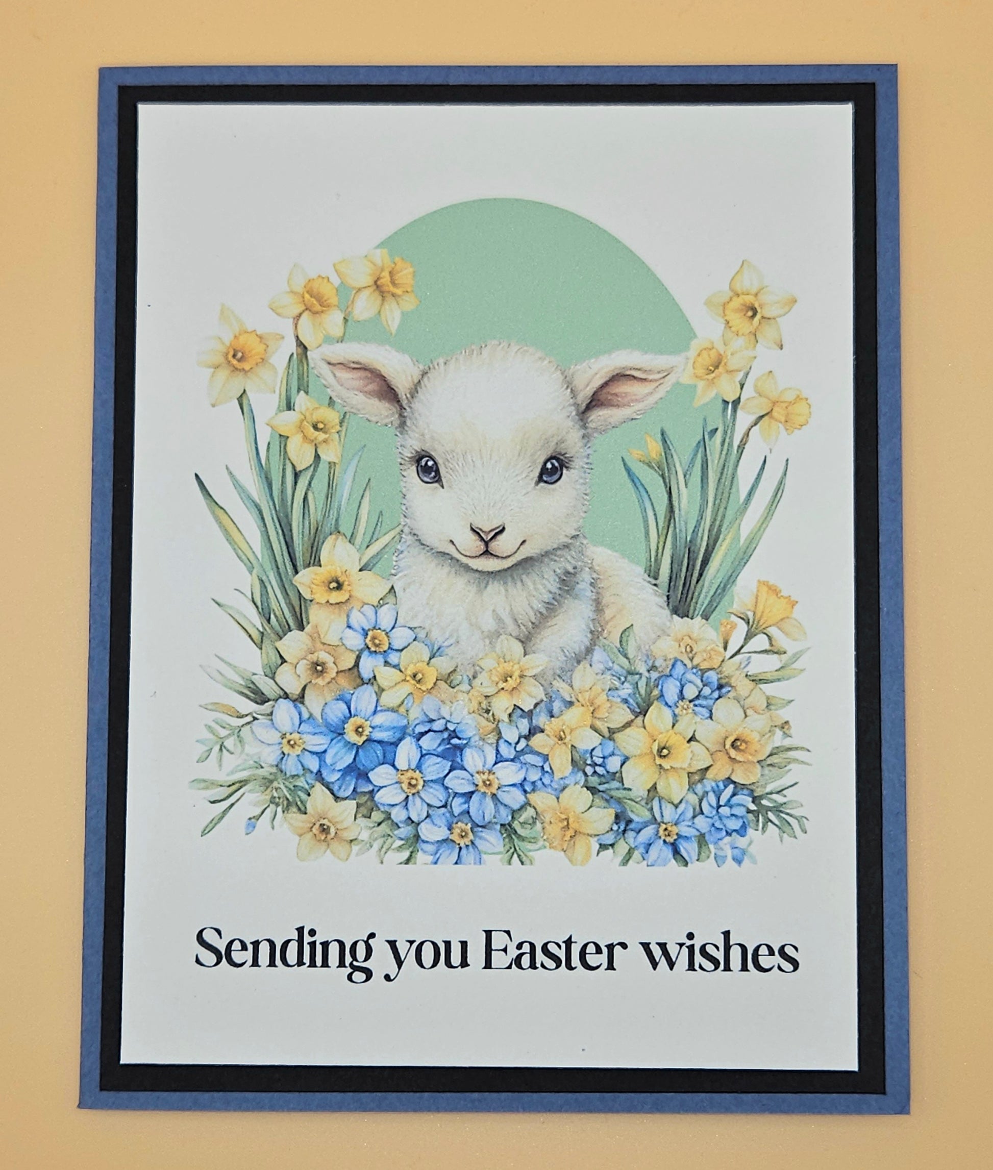 Framed Easter card with a lamb and flowers on a beige background