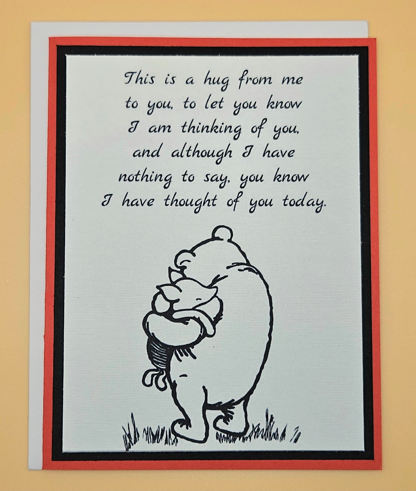 Card with a bear hugging a child and text on a beige background