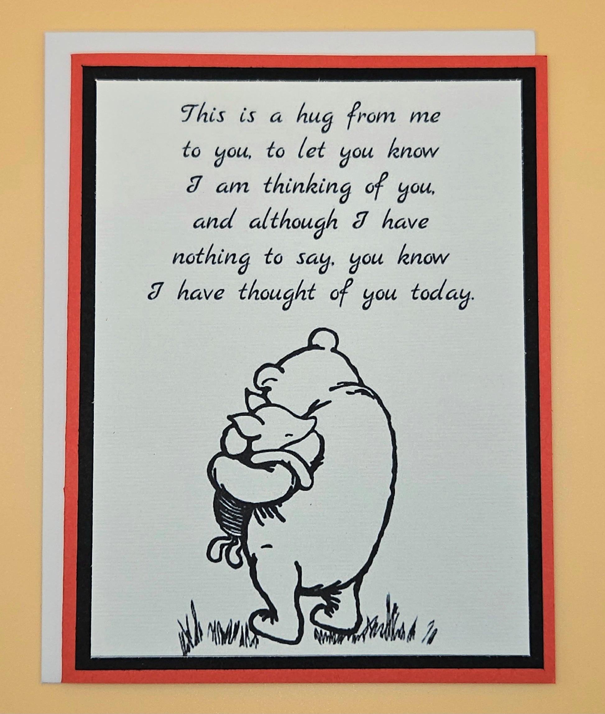 Card with a bear hugging a child and text on a beige background