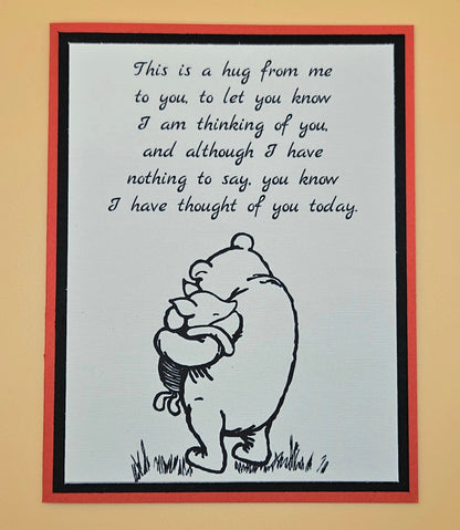 Card with a bear hugging a heart and text on a beige background