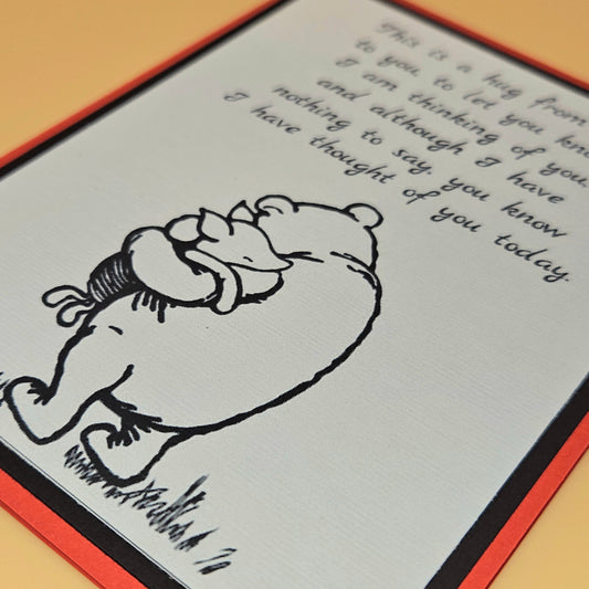 Greeting card with a bear illustration and handwritten text on a wooden surface