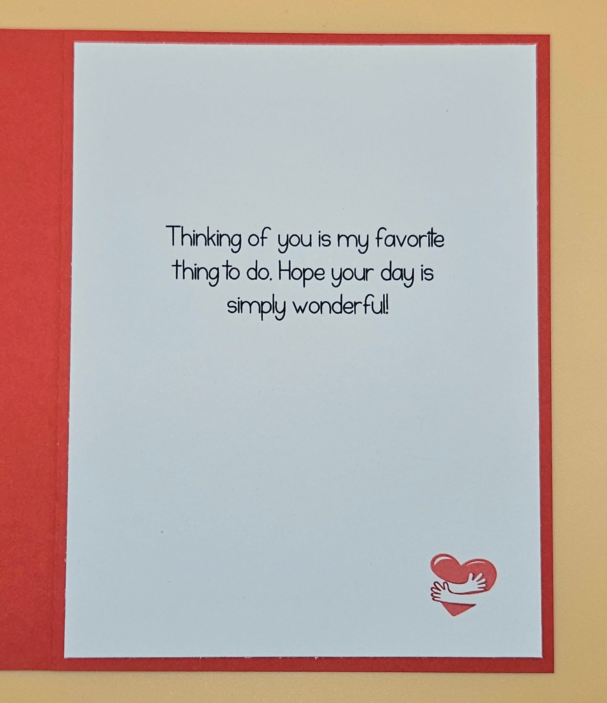 Greeting card with text 'Thinking of you is my favorite thing to do. Hope your day is simply wonderful!' and a heart design on a red border.