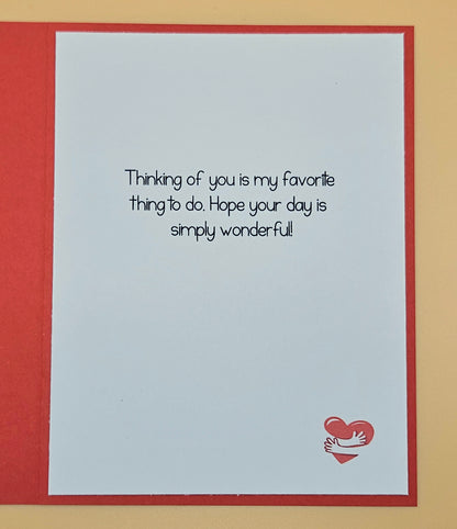 Greeting card with text 'Thinking of you is my favorite thing to do. Hope your day is simply wonderful!' and a heart design on a red border.