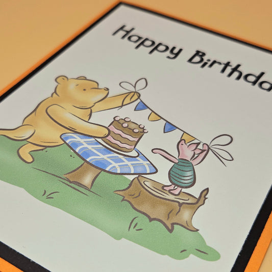 Cartoon bear and rabbit on a birthday card with 'Happy Birthday' text.