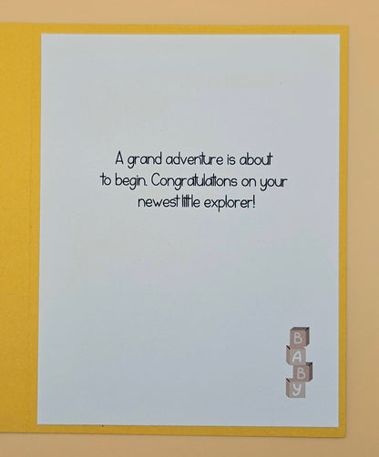 Baby shower card with text and 'BABY' blocks on a yellow border