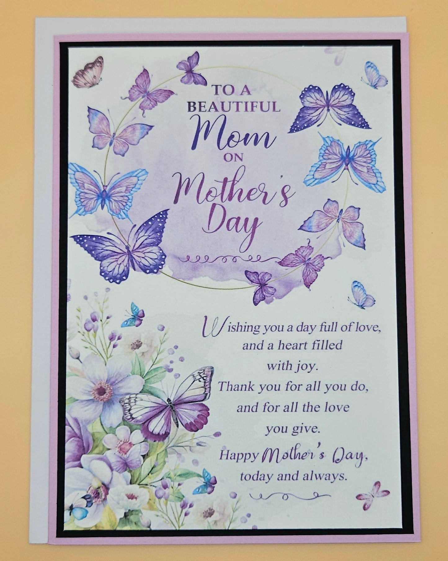 Mother's Day card with butterflies and flowers on a beige background