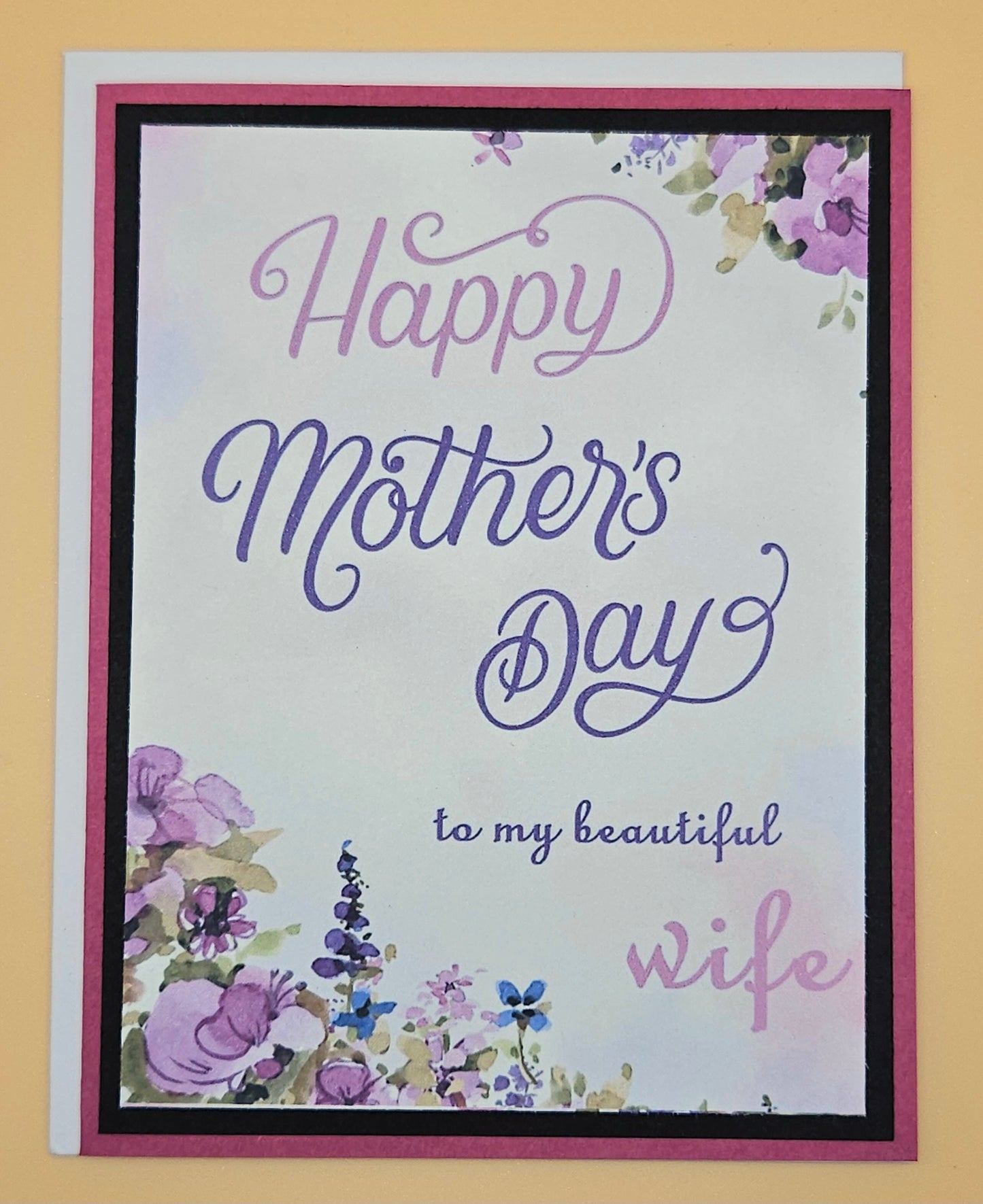 Greeting card with 'Happy Mother's Day to my beautiful wife' text and floral designs on a yellow background