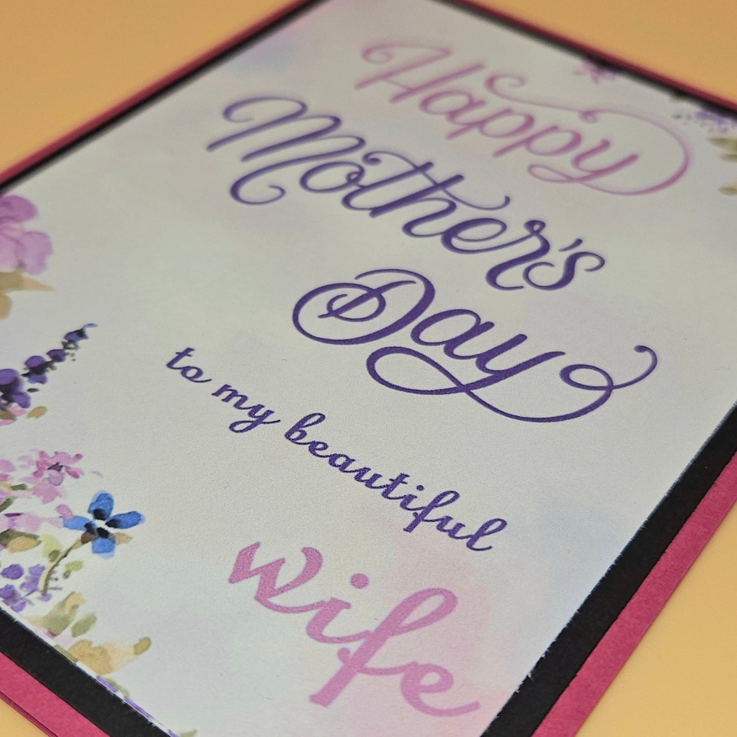 Greeting card with 'Happy Mother's Day to my beautiful wife' text on a floral background.