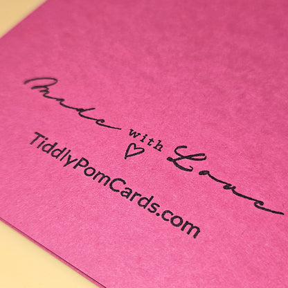 Pink card with 'Made with Love' and website text on a pink background