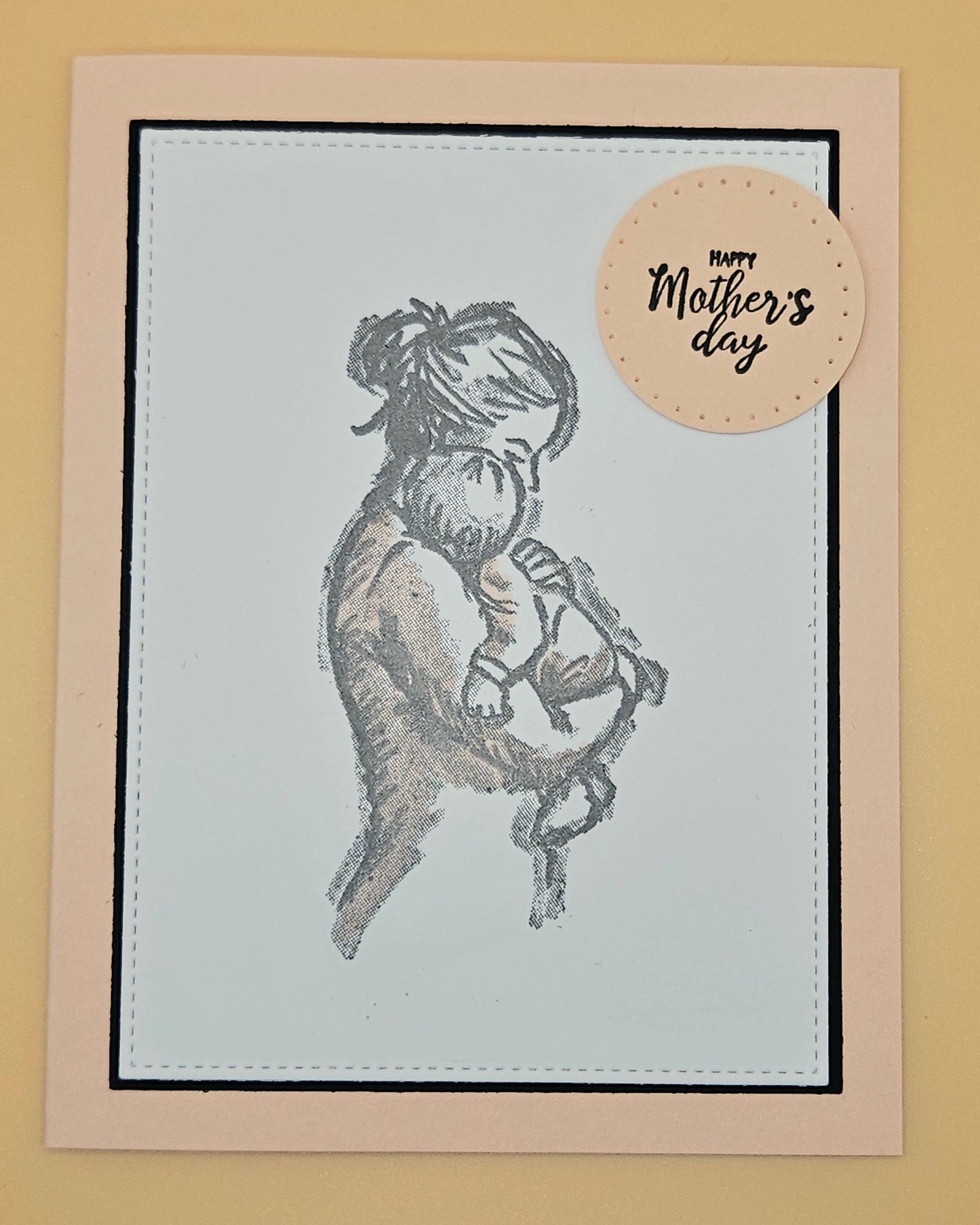 Greeting card with illustration of a woman holding a baby and 'Happy Mother's Day' tag on beige background