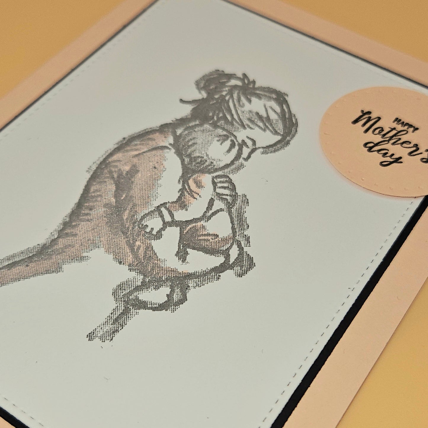 Greeting card with a drawing of a mother and child, and a 'Happy Mother's Day' sticker.