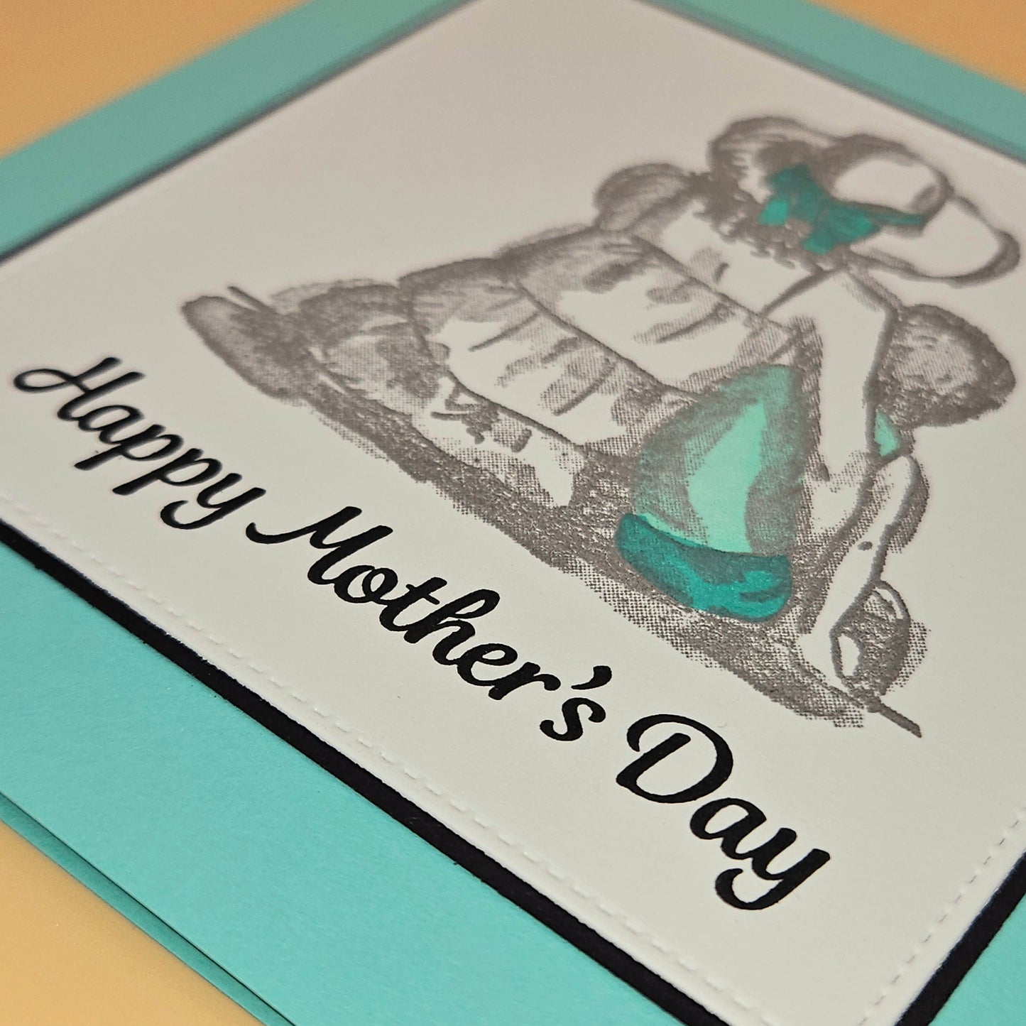 Mother's Day card with illustration of a woman and text on a light blue border