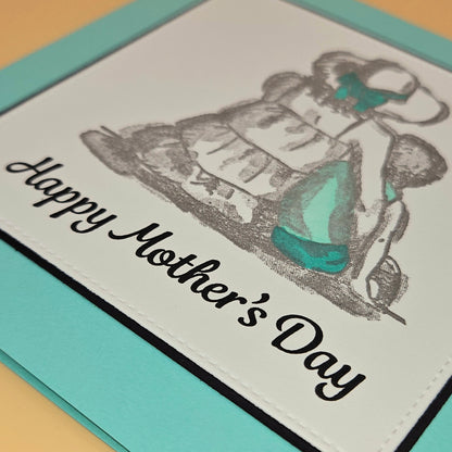 Mother's Day card with illustration of a woman and text on a light blue border