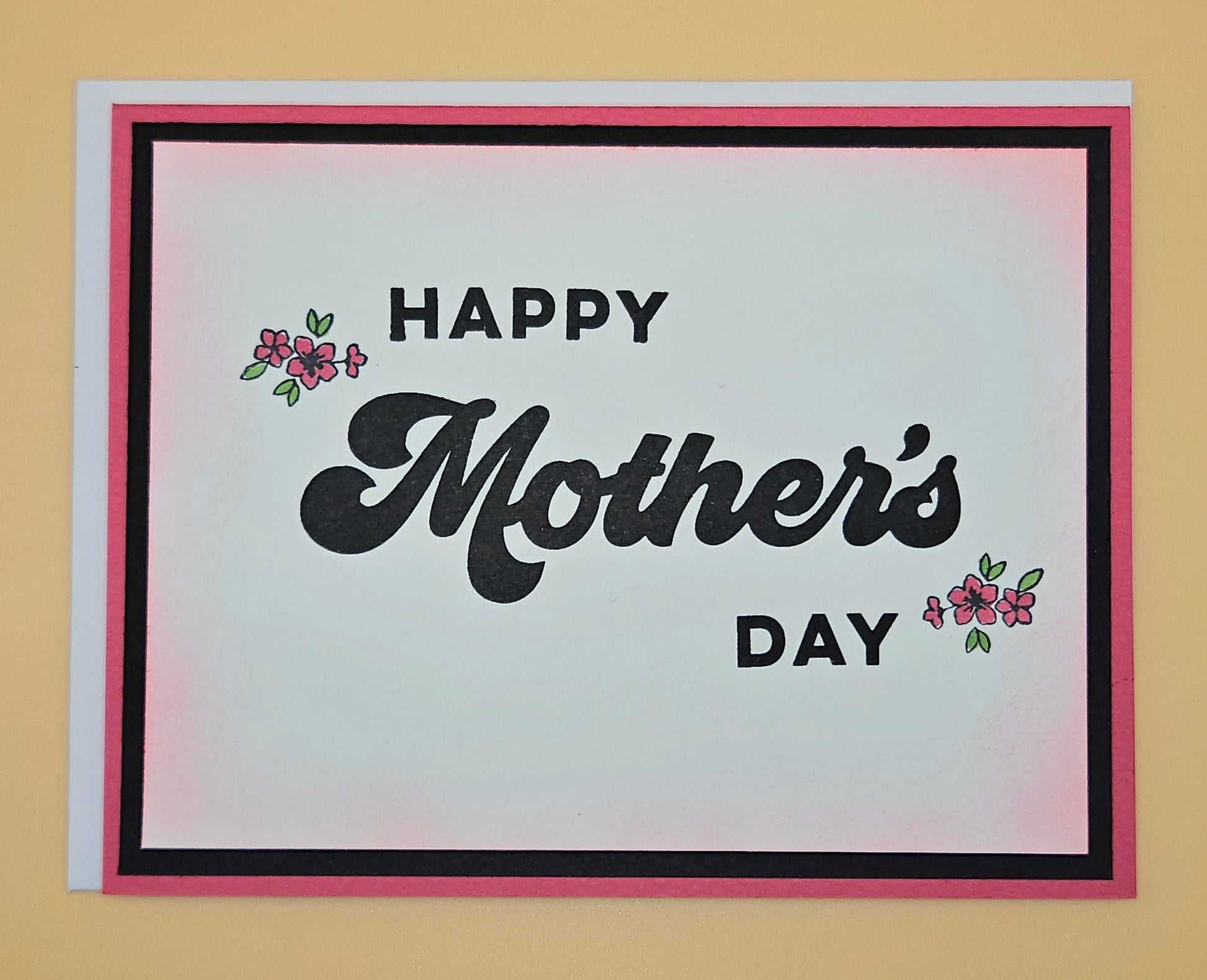 Mother's Day card with 'Happy Mother's Day' text on a plain background