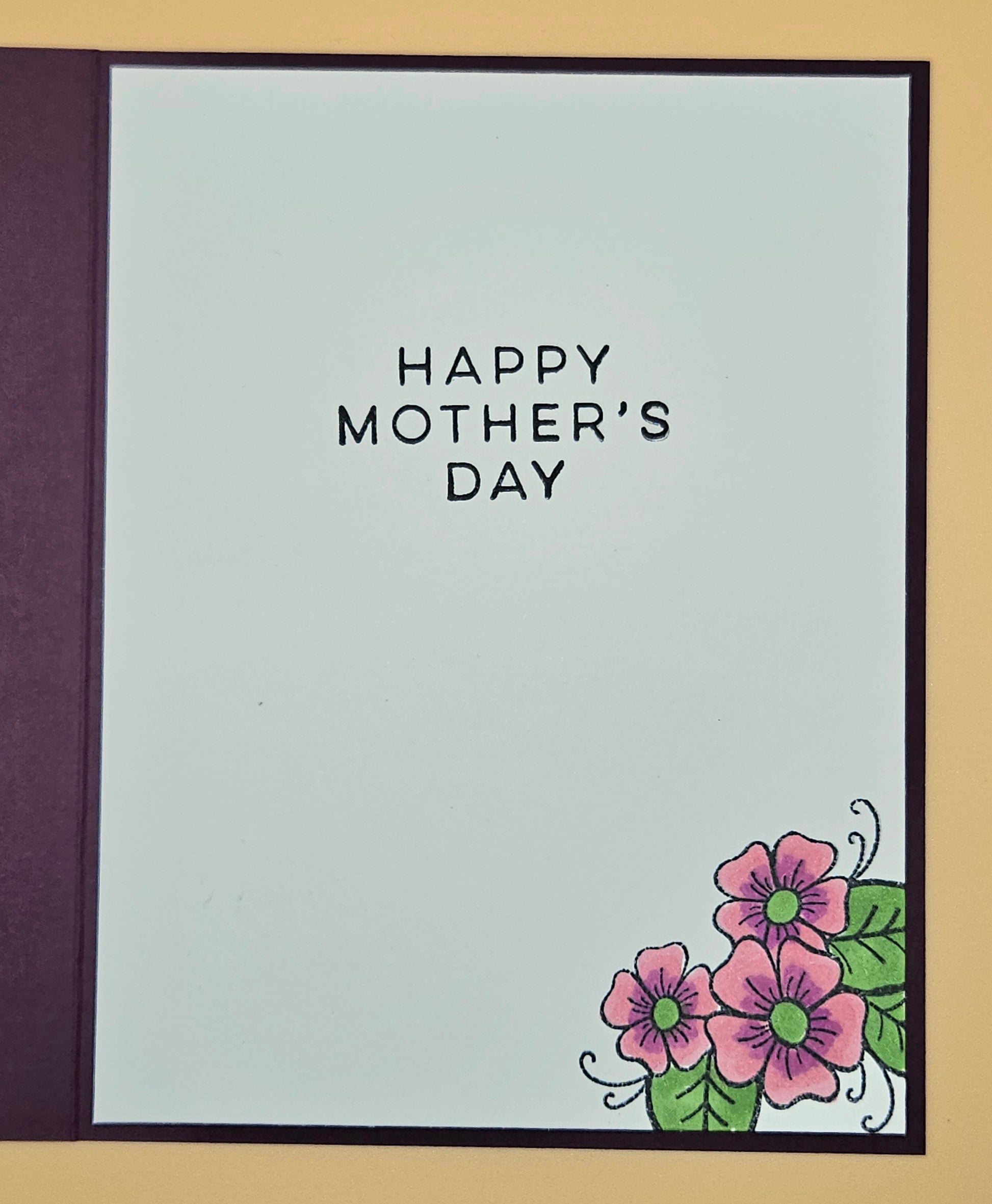 Mother's Day card with flowers and 'Happy Mother's Day' text on a light blue background.