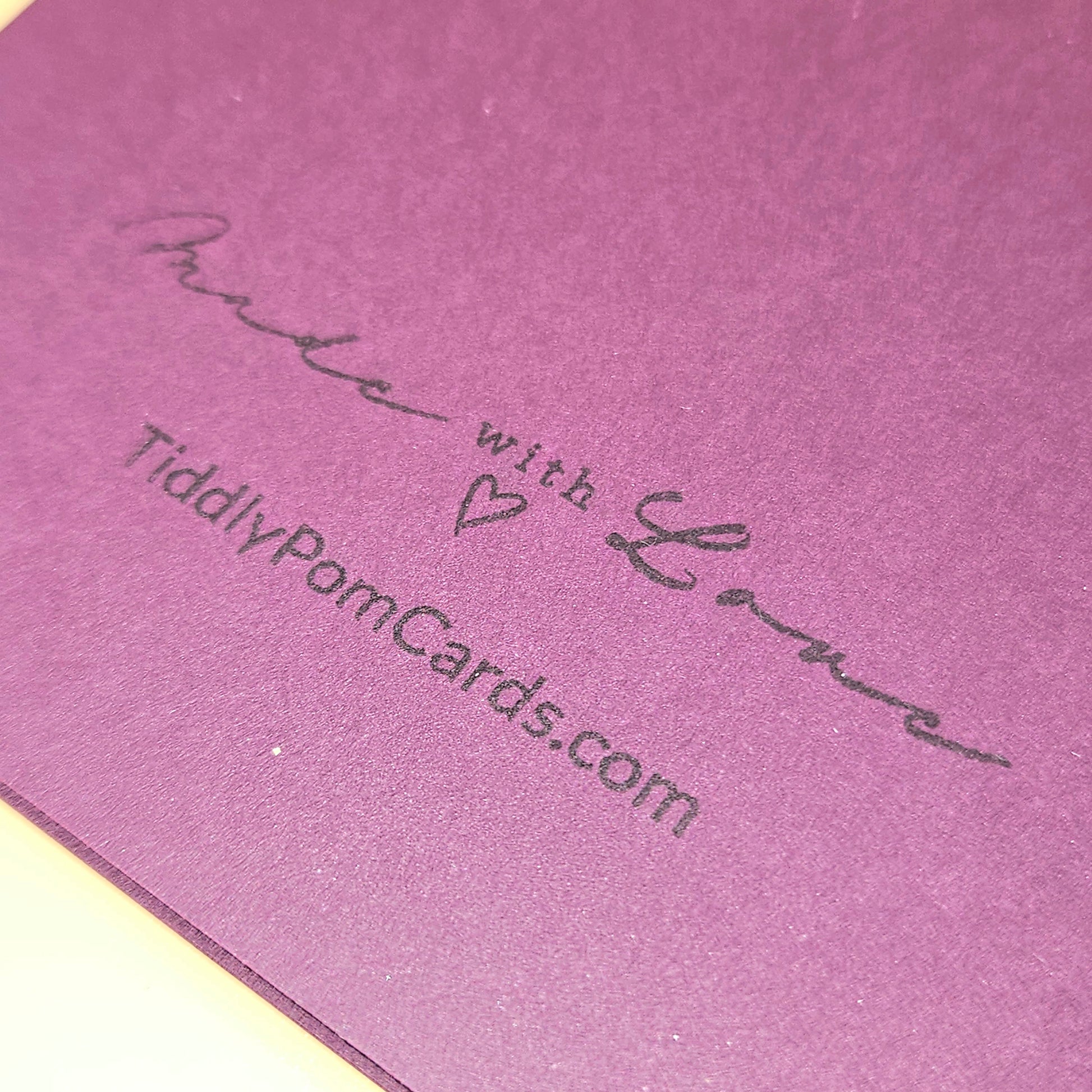 Purple card with 'Made with Love' and a website address printed on it.