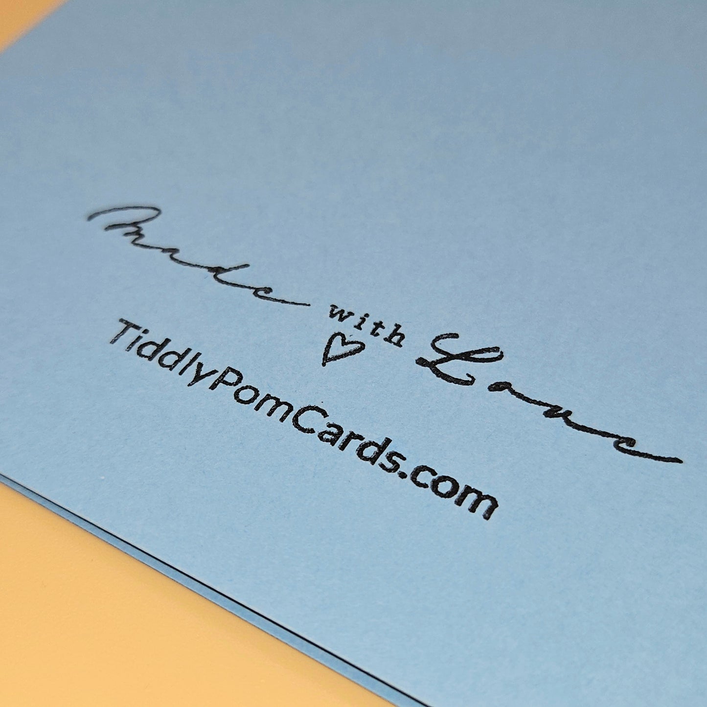 Blue card with 'Made with Love' and 'TiddlyPomCards.com' text on a yellow border.