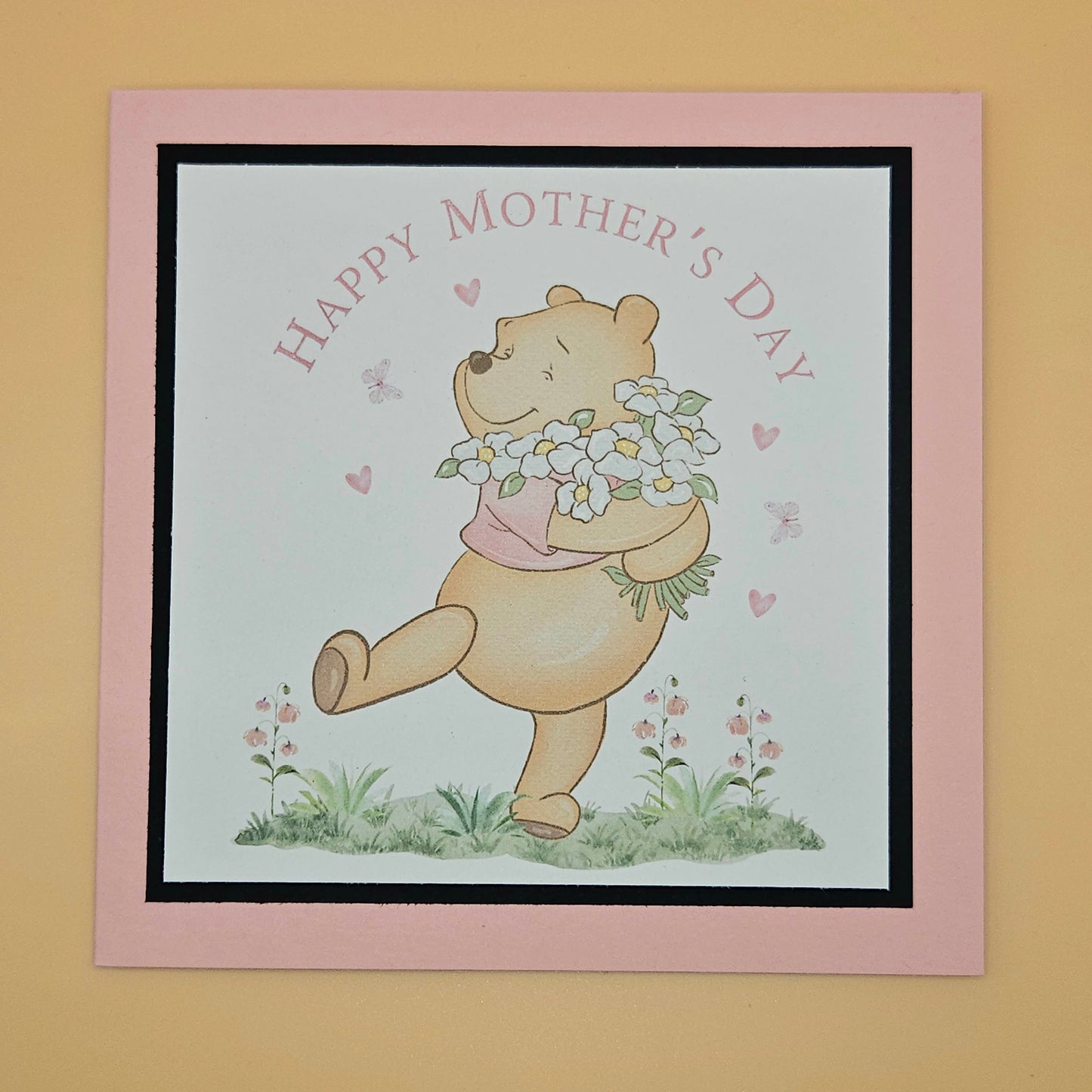 Card with a bear holding flowers and 'Happy Mother's Day' text on a pink border.