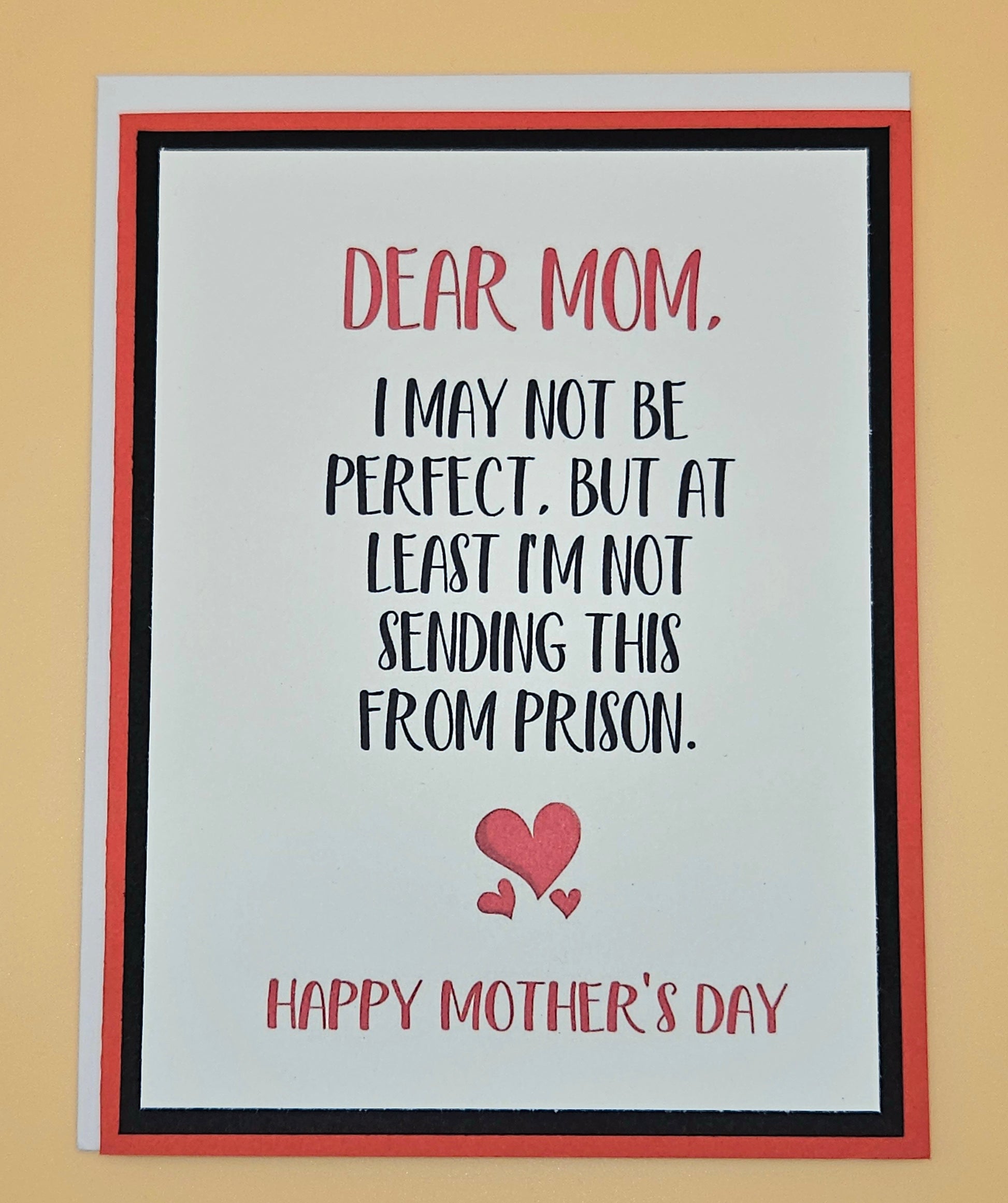 Mother's Day card with humorous message and heart design on a beige background